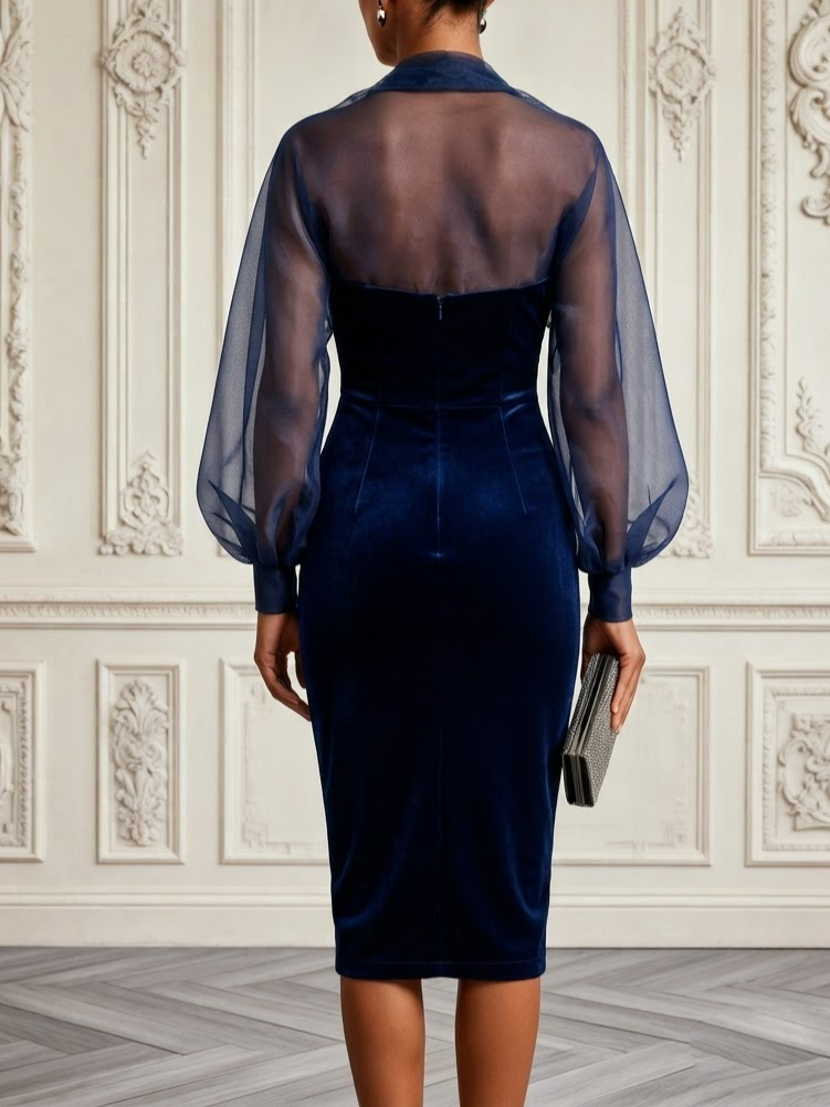 Back view of navy velvet midi dress with sheer upper panel and sleeves
